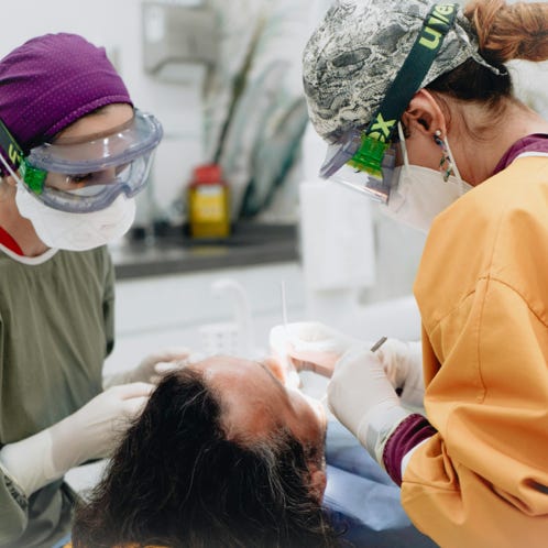 Dentists Treating Patient Teeth 