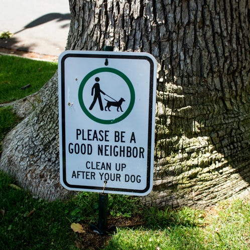 A Plate Informing About Cleaning After Your Dog 